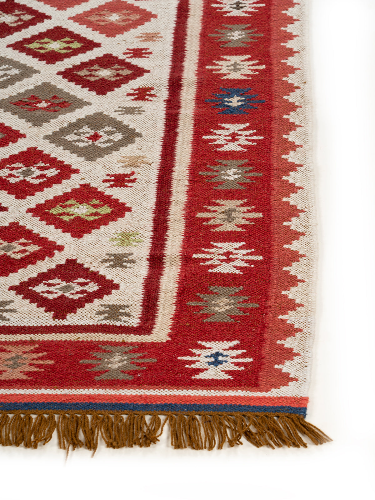 The Rustic Diamond Rug wool rug styled in a living room interior