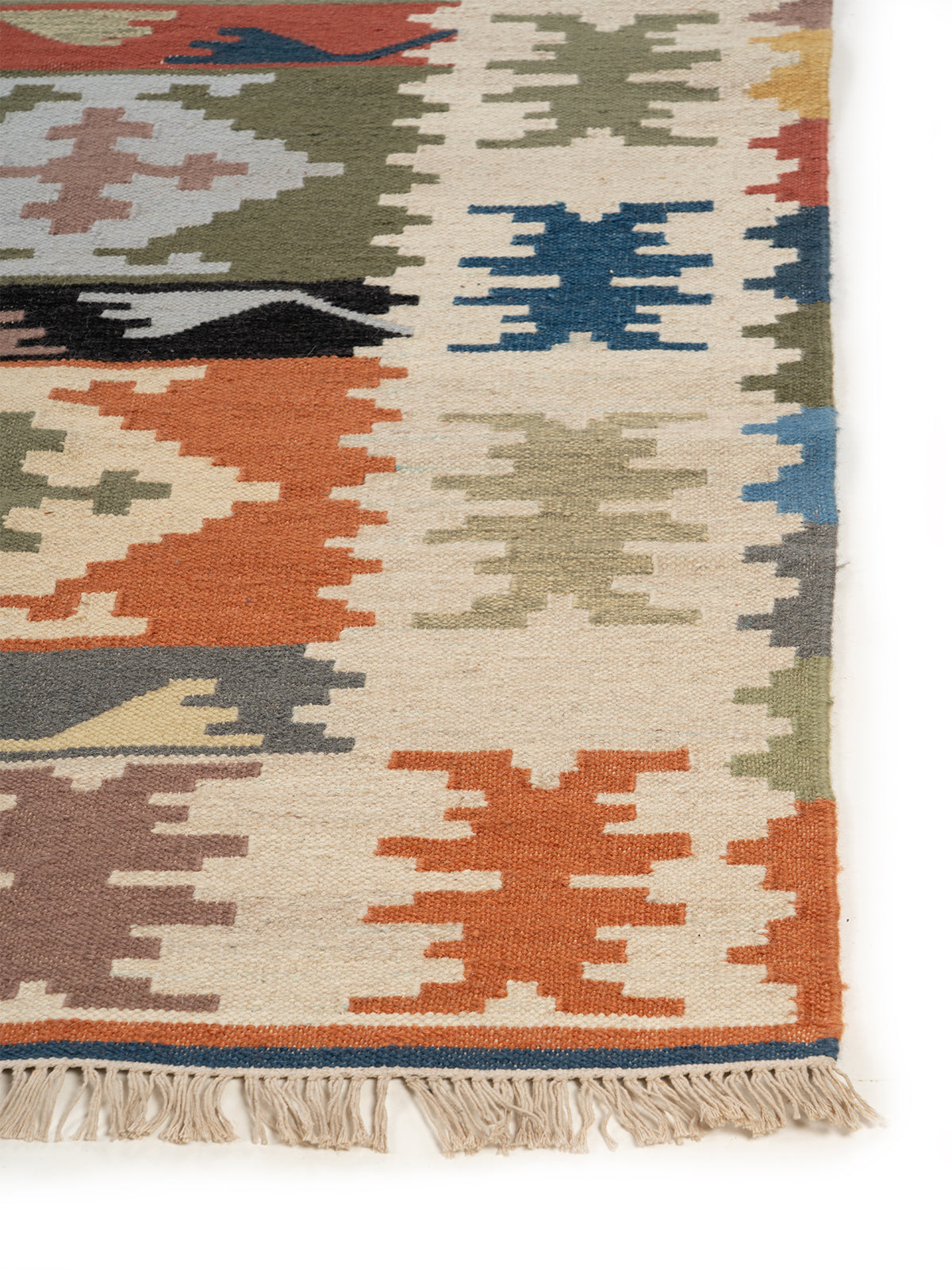 The Rustic Village Rug wool rug styled in a living room interior