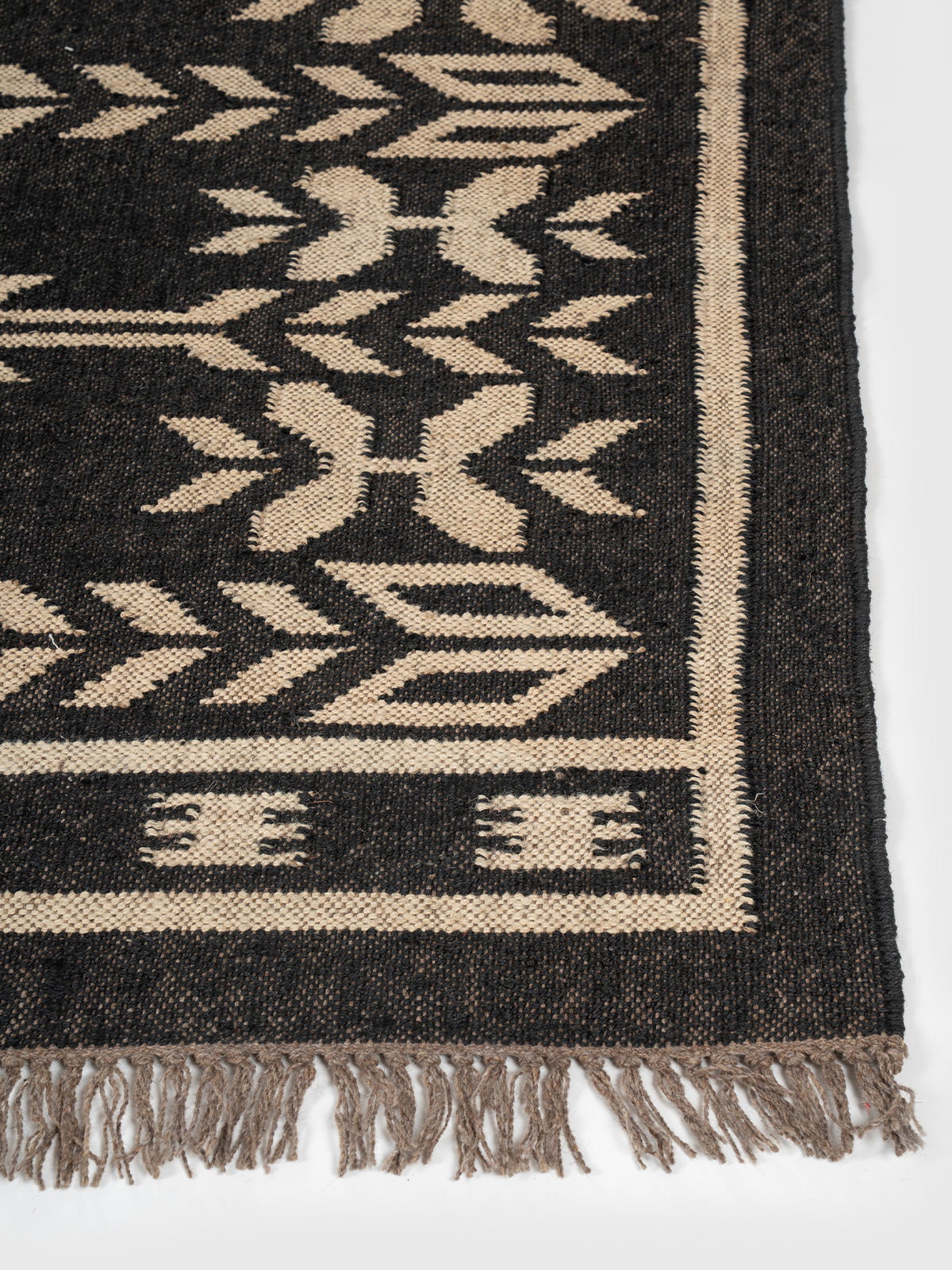 The Sky Strata Rug wool rug styled in a living room interior