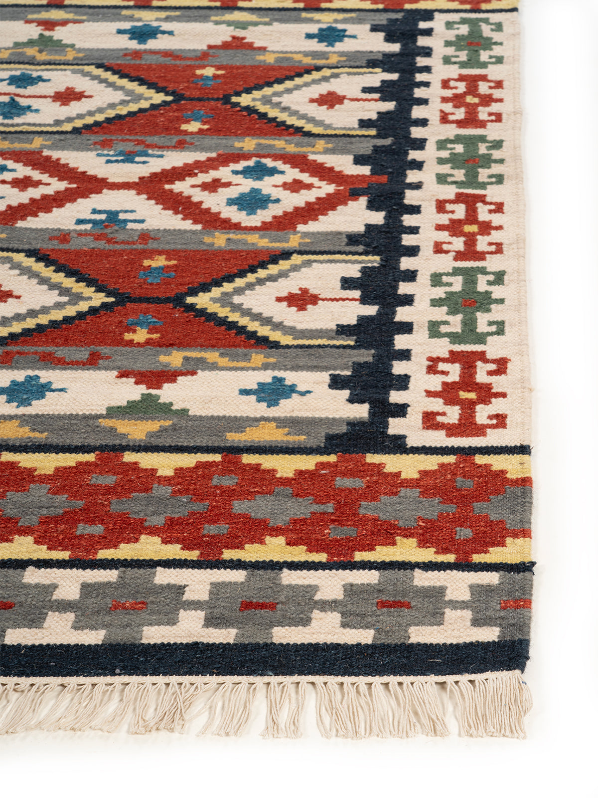The Tribal Fortress Rug wool rug styled in a living room interior
