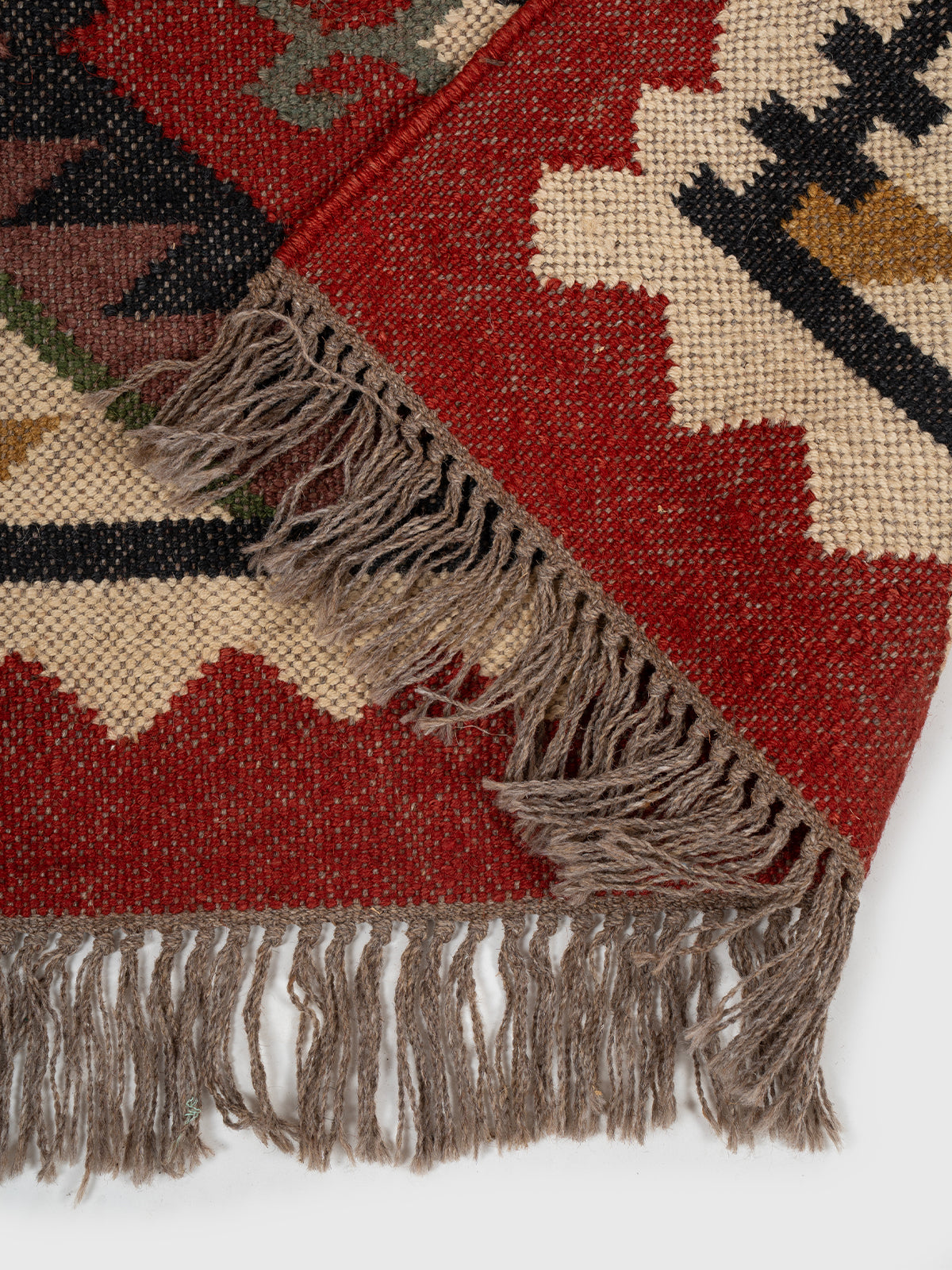 The Tribal Gem Runner detail showing edge binding and wool finishing of the runner