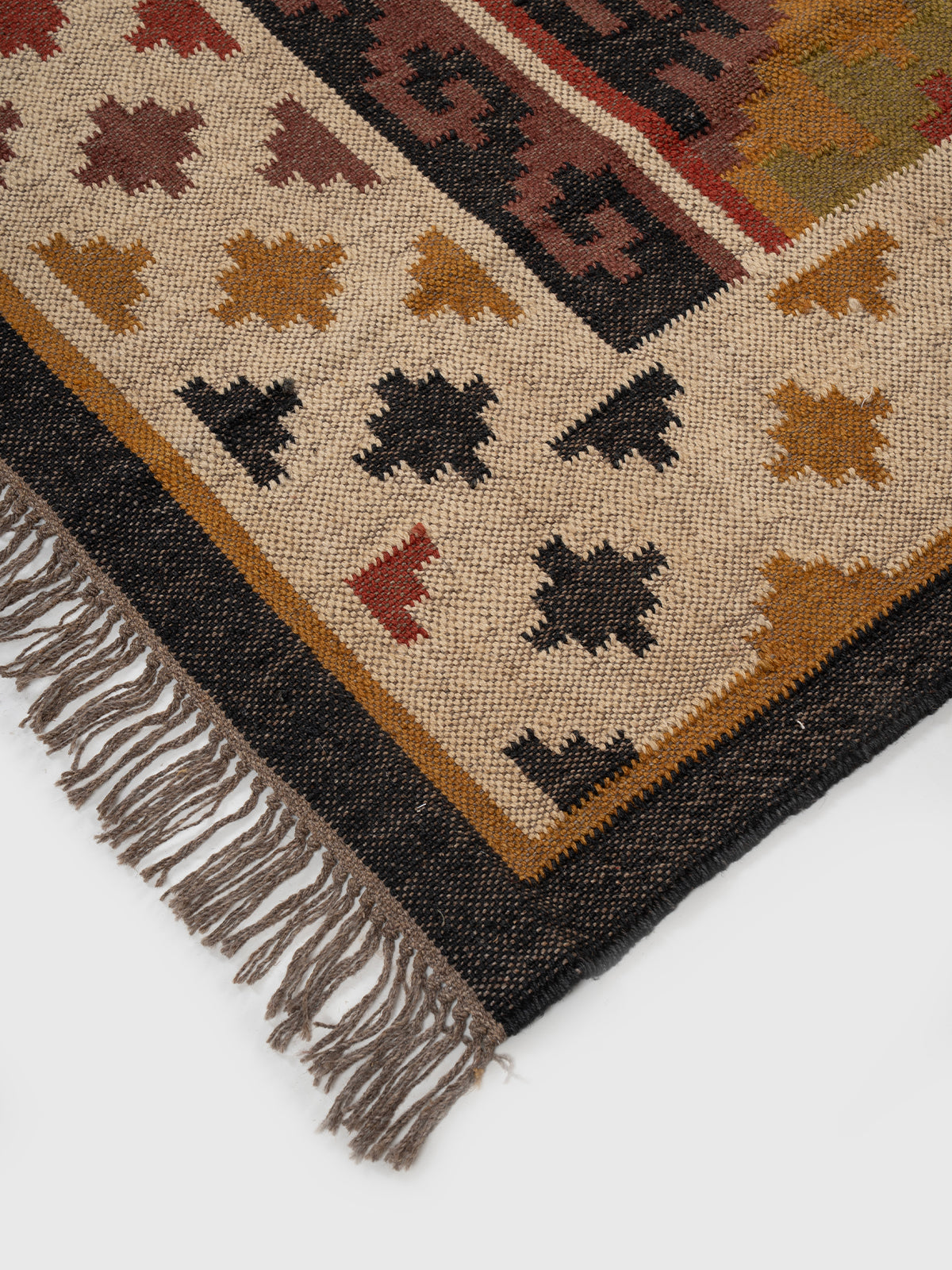 The Tribal Medley Kilim close-up showing the wool weave and traditional motif