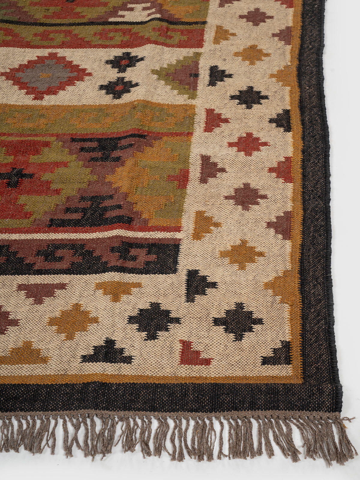 The Tribal Medley Kilim wool rug styled in a living room interior