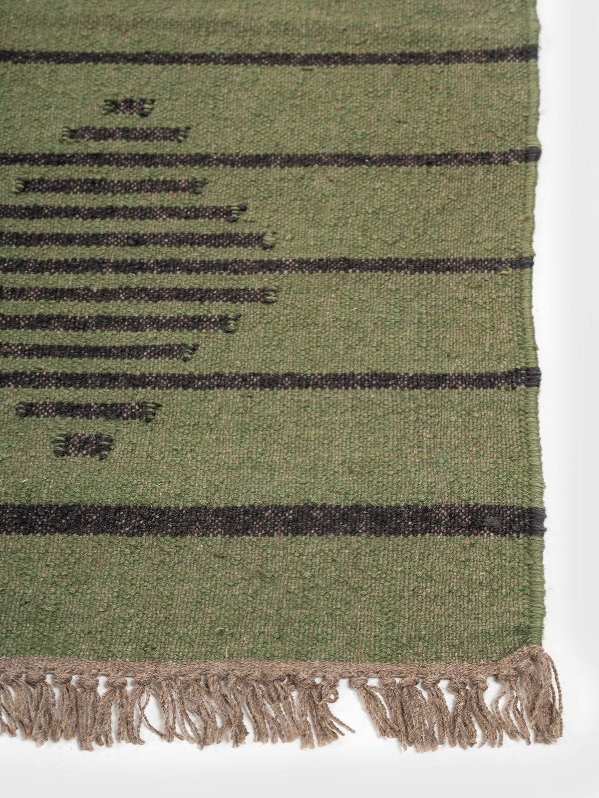 The Verdant Stripe Kilim wool rug styled in a living room interior