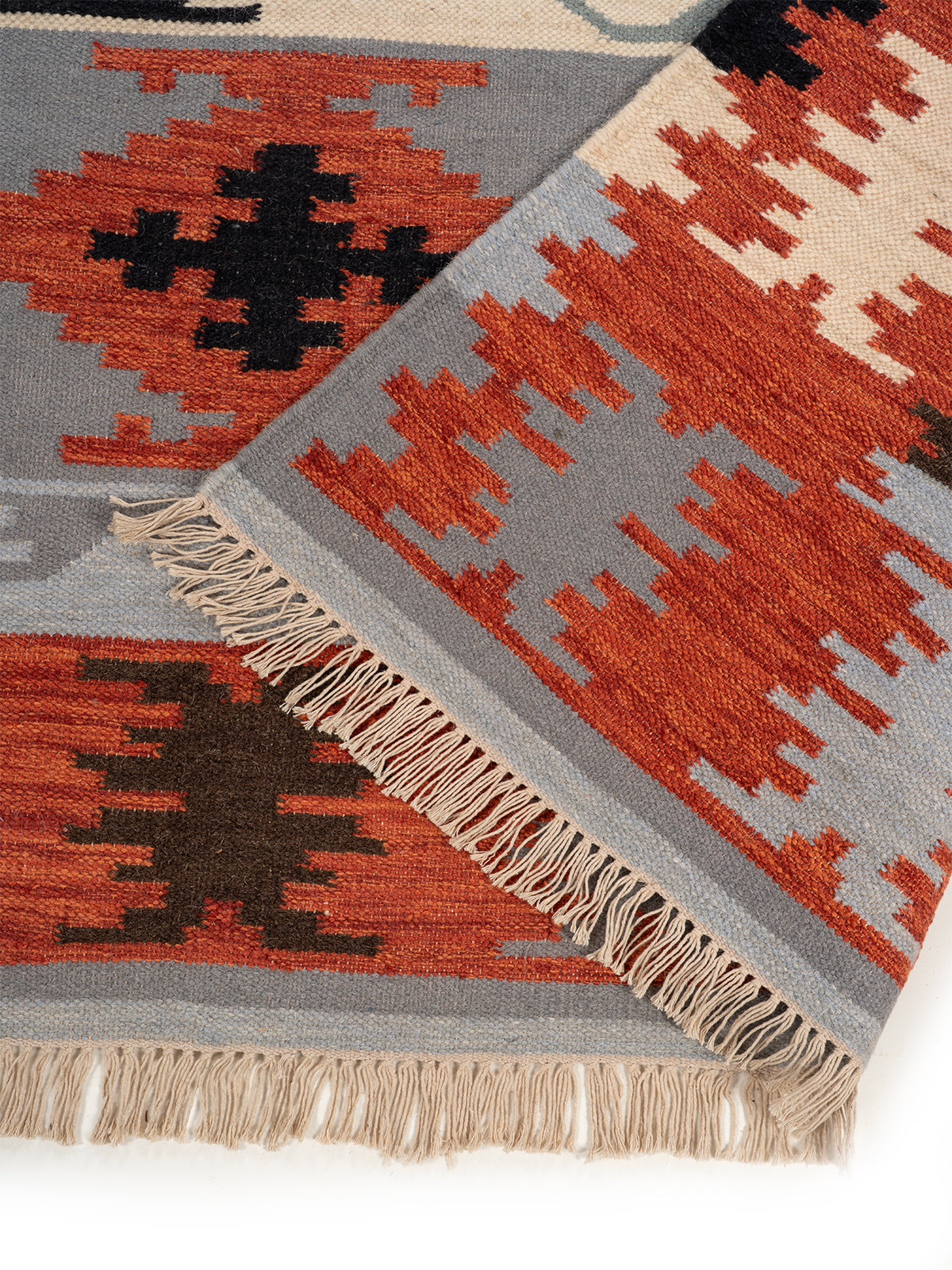 The Warm Stone Rug detail showing the textured wool surface and finishing