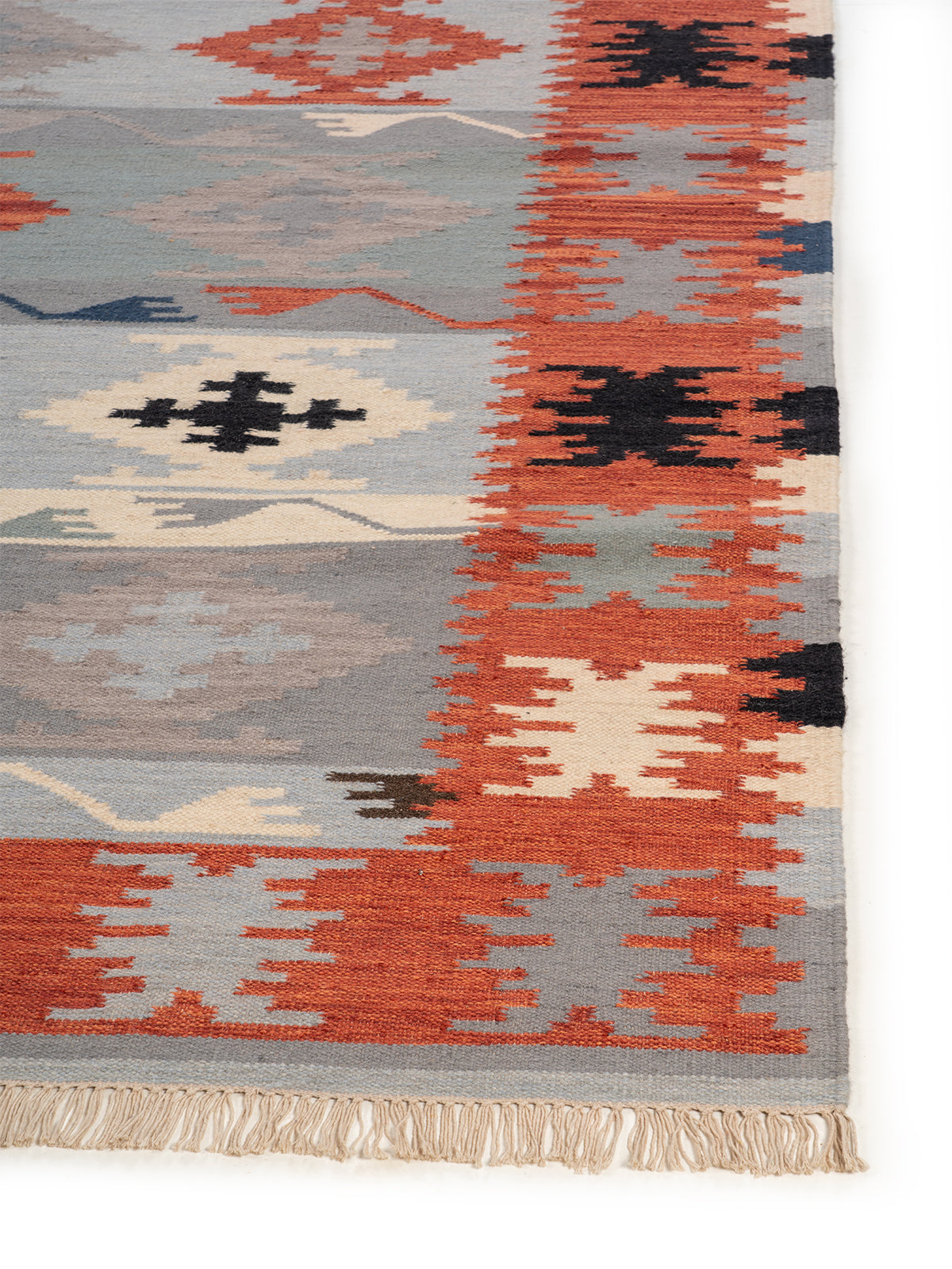 The Warm Stone Rug wool rug styled in a living room interior