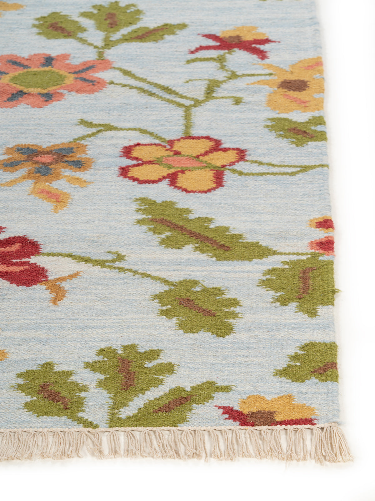 The Wildflower Bloom Rug wool rug styled in a living room interior