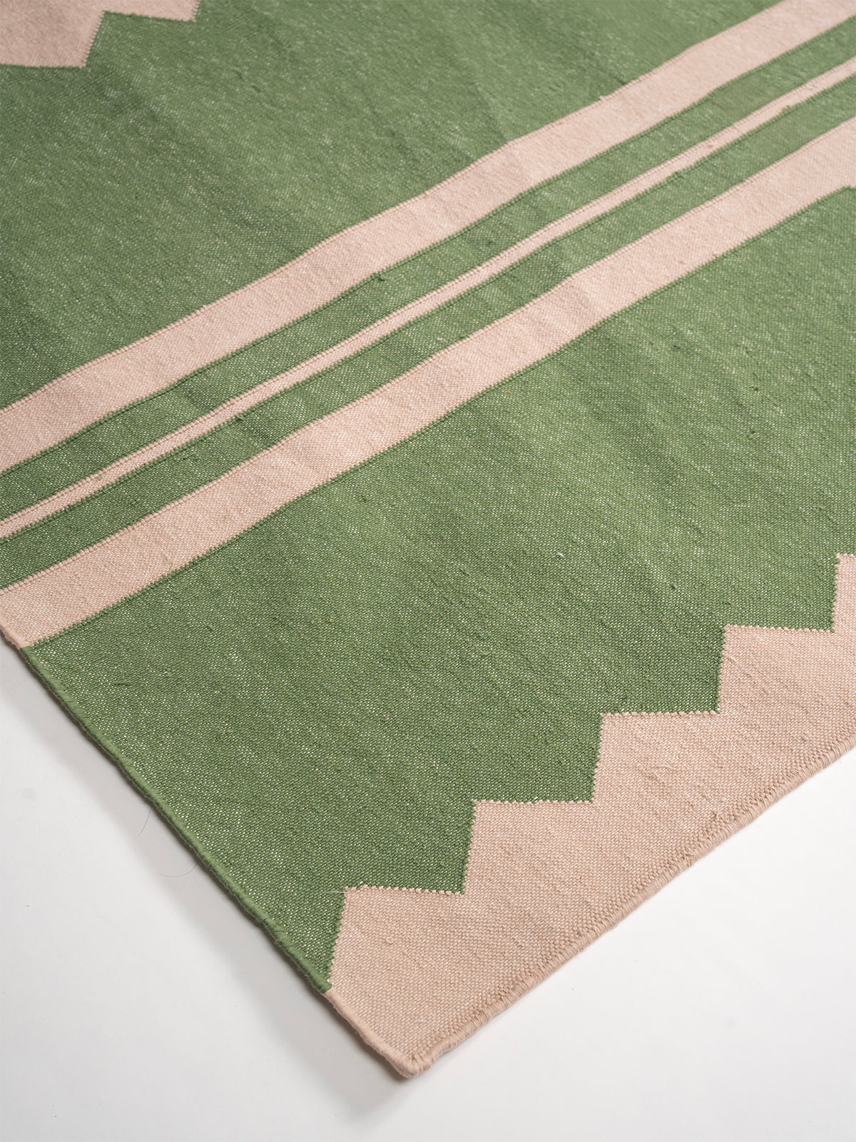 The Zigzag Trail Runner- Basil - cotton runner laid in a hallway view