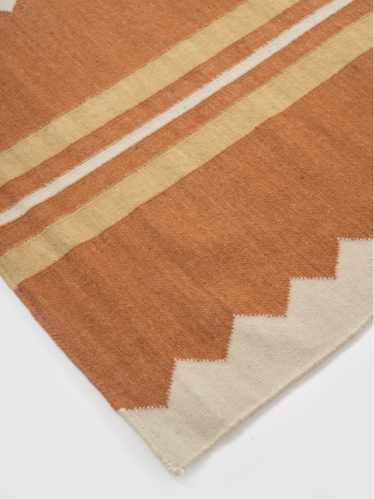 The Zigzag Trail Runner-Rust close-up showing the cotton weave and geometric surface