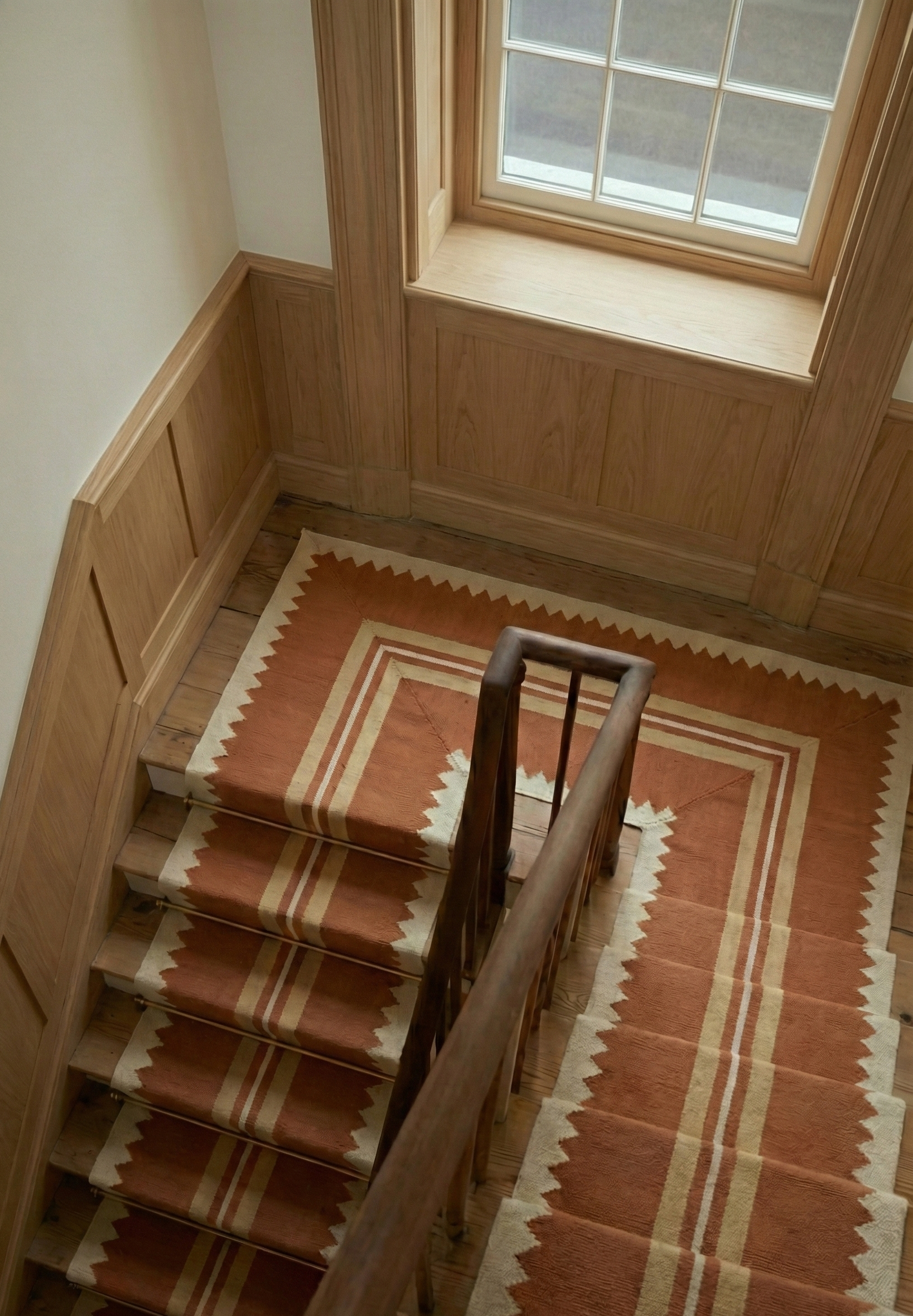 The Zigzag Trail Runner-Rust cotton stair runner styled on a staircase in a designed interior