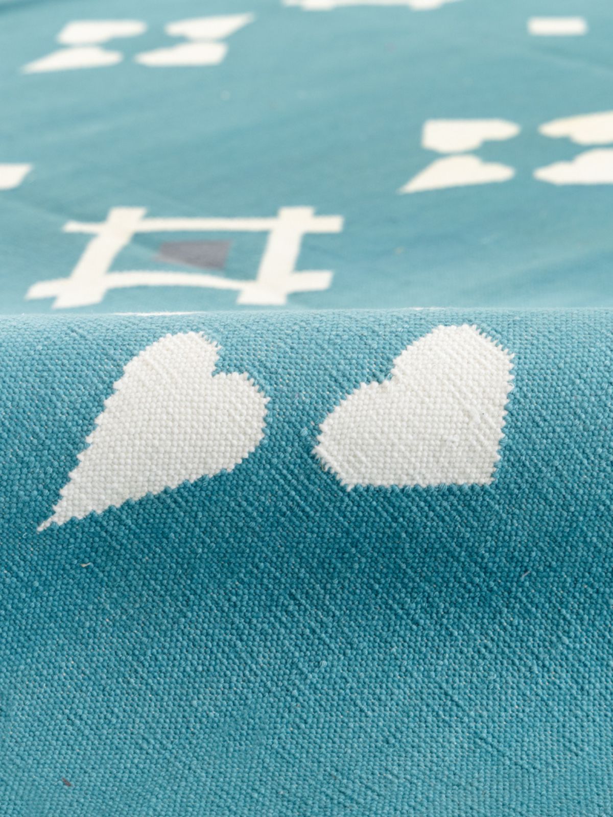 Turquoise Flatweave rug detail showing the textured cotton surface and finishing