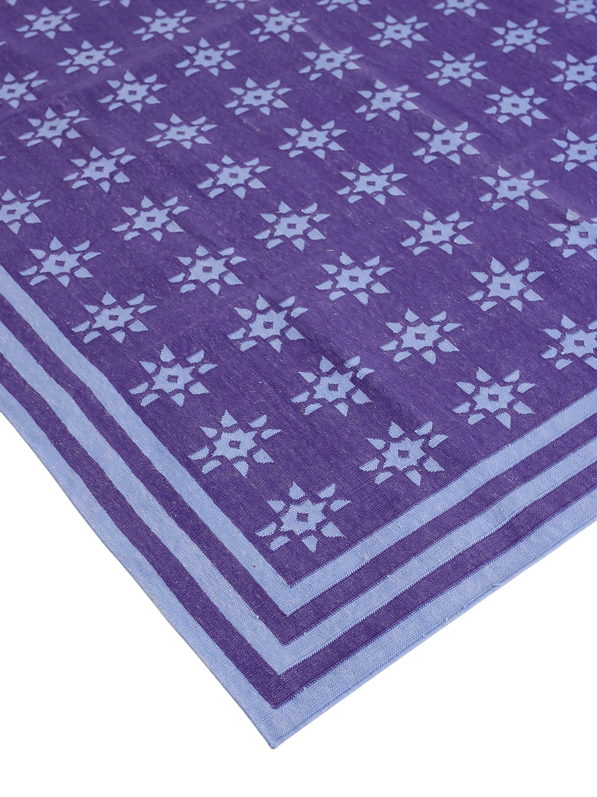 Violet Starfall Flatweave Rug close-up showing the cotton weave and geometric motif