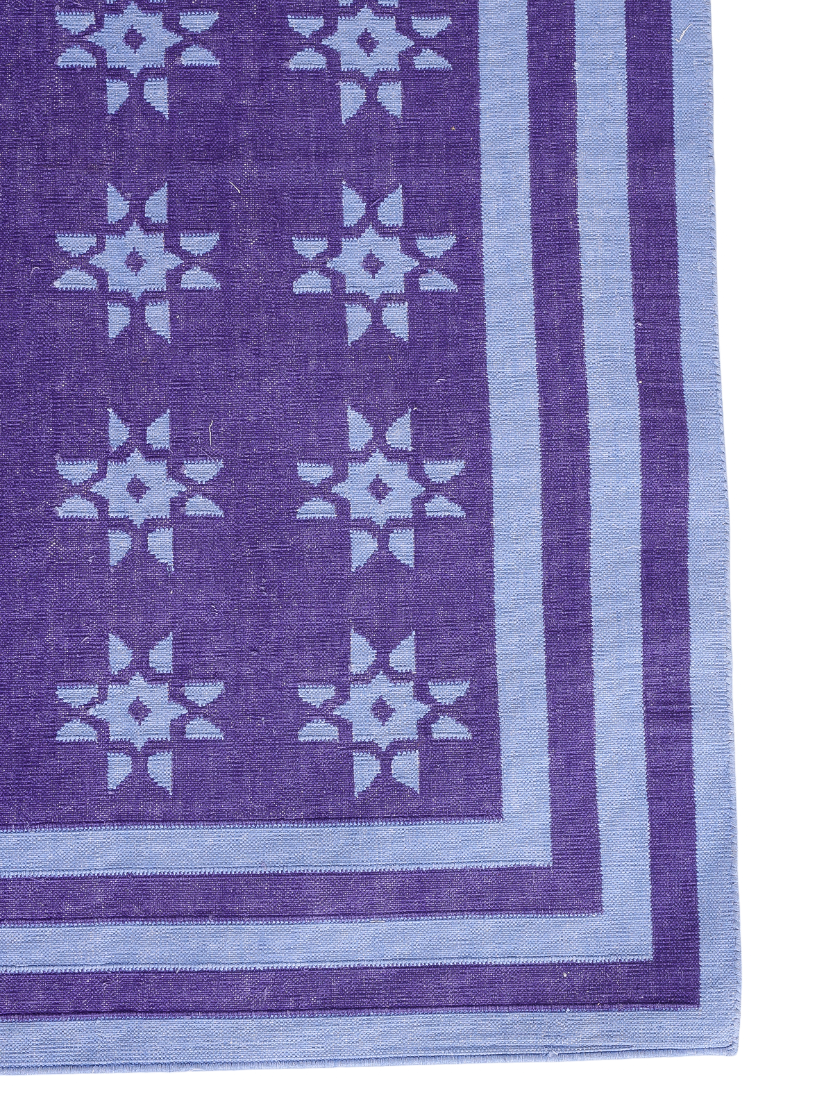 Violet Starfall Flatweave Rug cotton rug styled in a living room interior