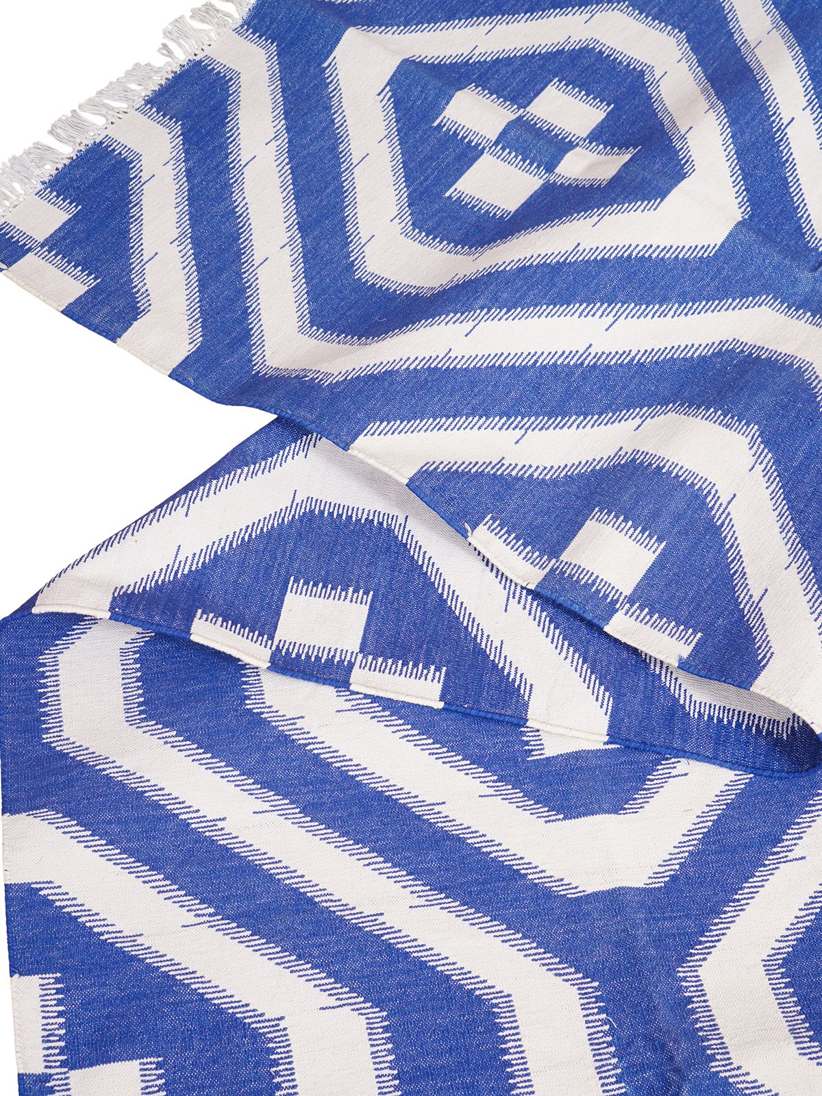 White Wave Ikat Flatweave Rug detail of the geometric pattern in cotton